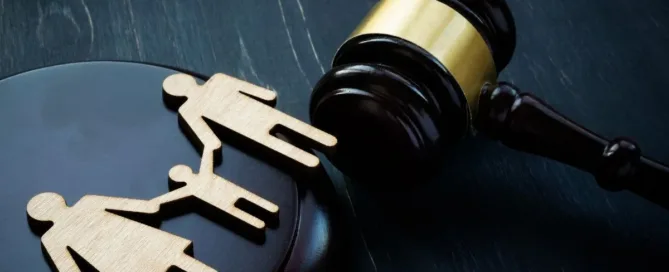 Martelo de juiz ao lado de figuras de pai, mãe e filho representando decisão sobre guarda compartilhada ou unilateral