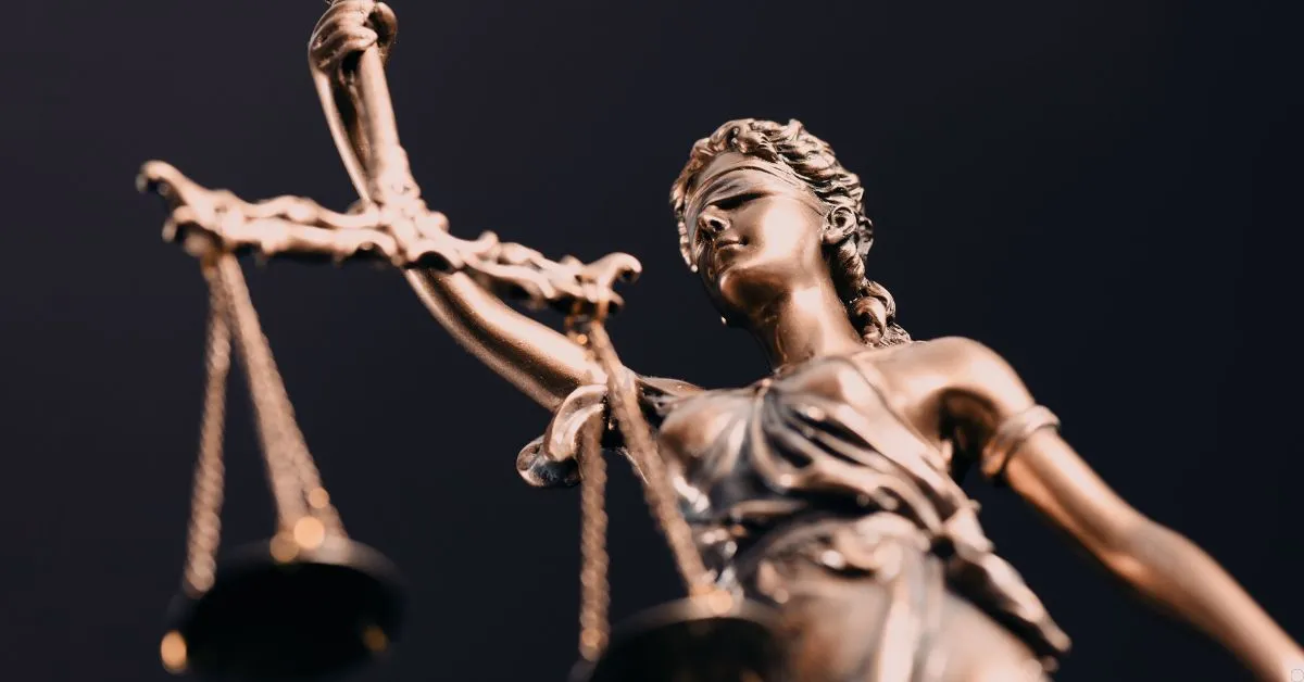 Estátua da justiça segurando balança, simbolizando o direito à indenização por dano moral