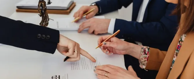 Pessoas assinando acordo extrajudicial orientadas por profissional jurídico, representando validade legal do documento.