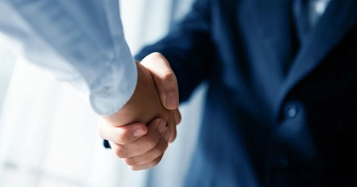 Sócios apertando as mãos após acordo de dissolução de sociedade
