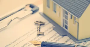 Contrato, chave e imóvel representando multa por rescisão de contrato de locação